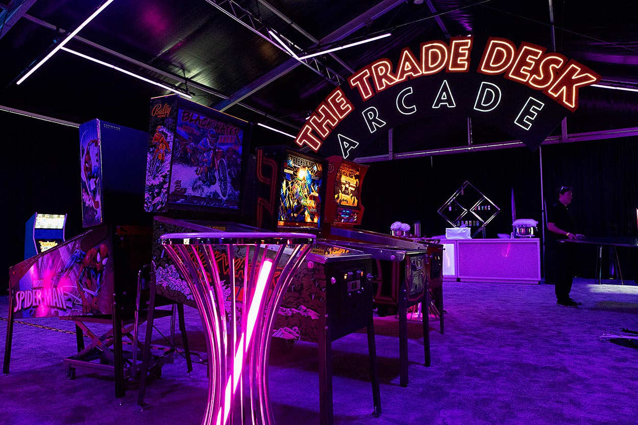 Neon signage for The TradeDesk Arcade with arcade machines
