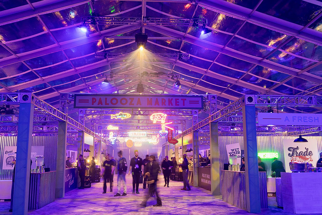 Palooza market signage with blurred people and blueish lighting