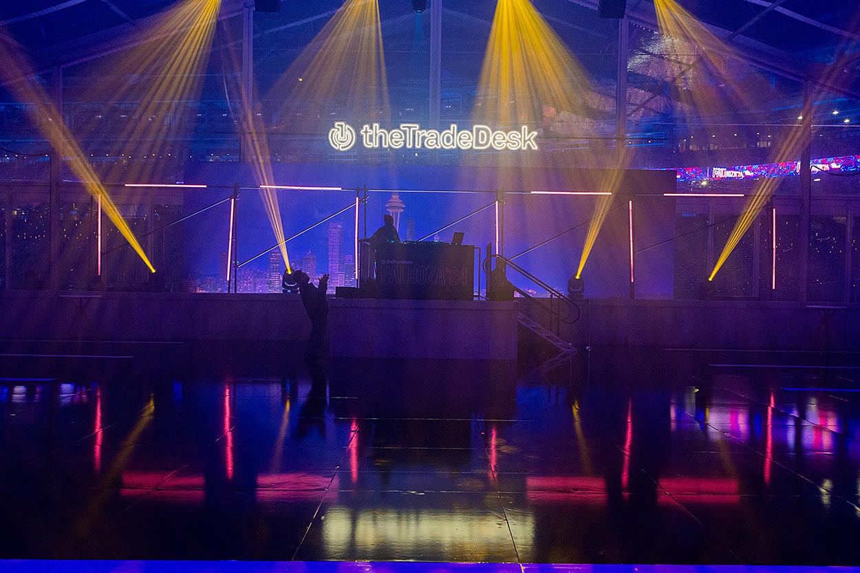 Trade Desk logo with DJ platform, lighting on reflective surfaces
