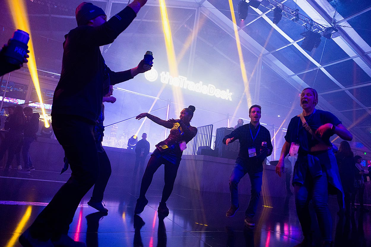 silhouette of four people on a dance floor with blue lighting