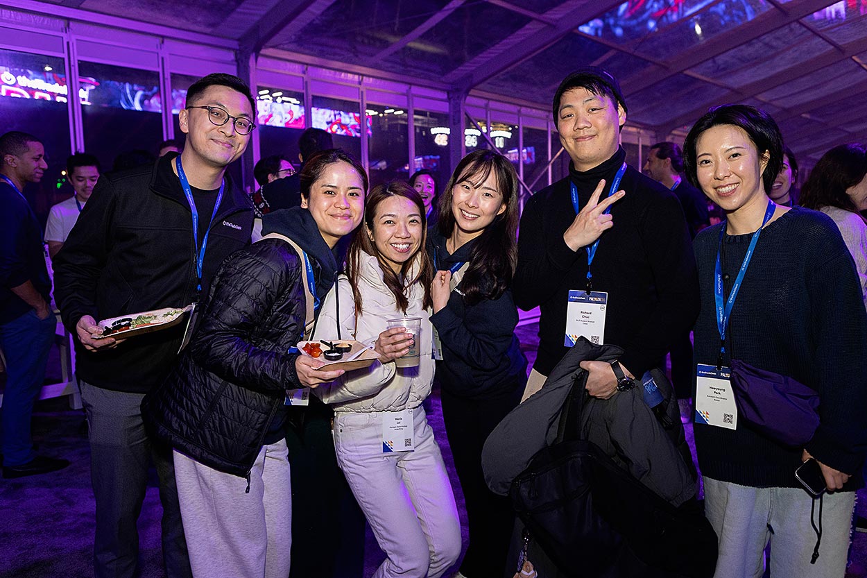 group of six event attendees smiling at the party