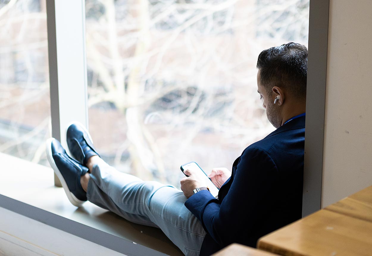 looking over the shoulder of a man sitting in a window frame
