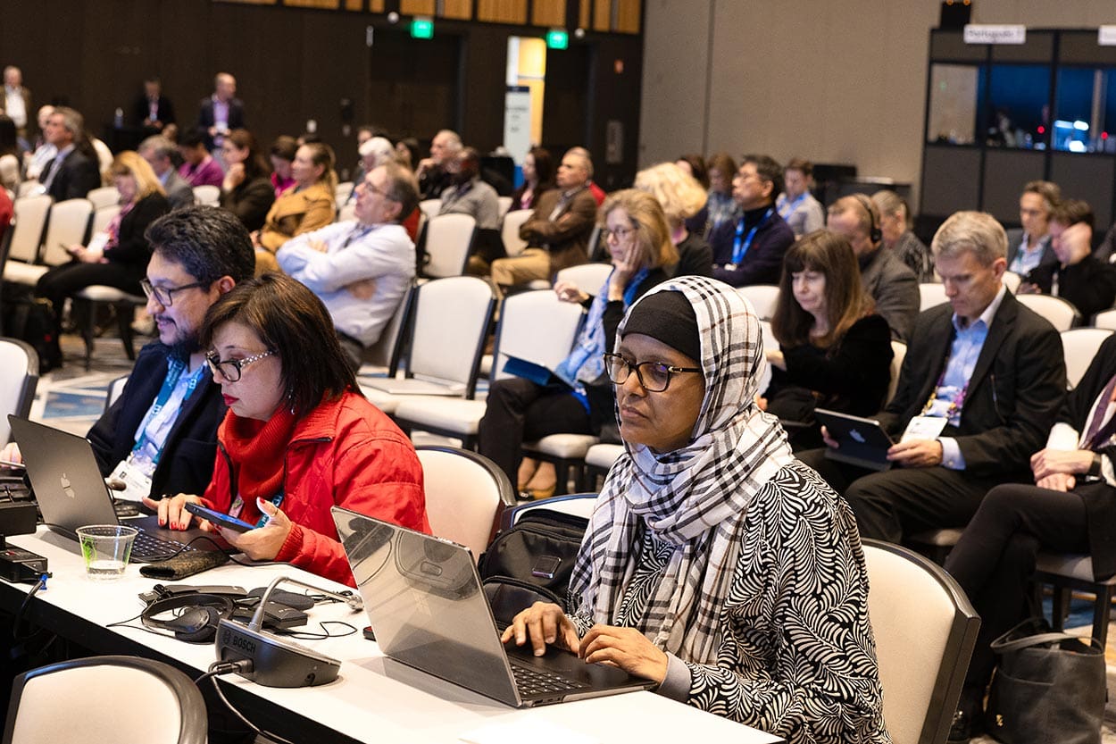 woman with hijab looking at compute, while at a seattle event