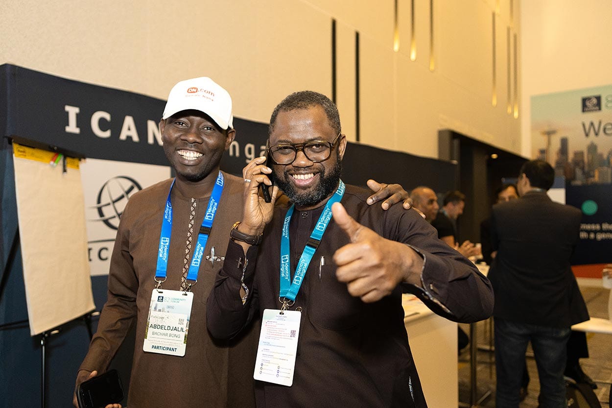 two conference attendees smiling