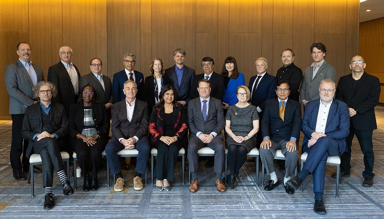 Group of twenty board executives- one row standing, one row sitting for a group photo