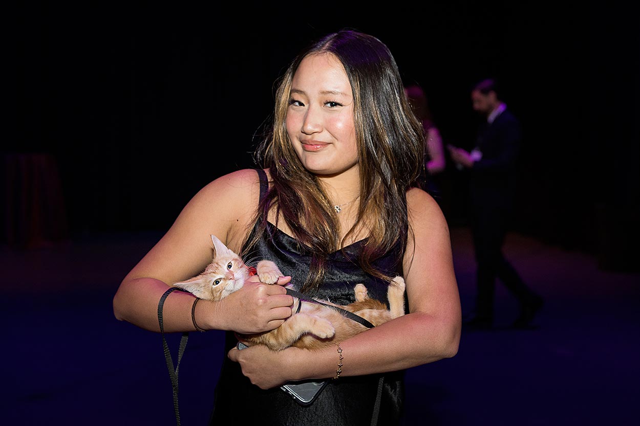 young woman holding a cute kitten at a fundraising event