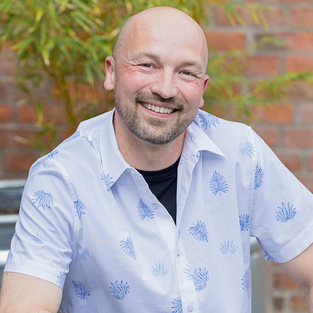 personal branding headshot with a man smiling and looking friendly