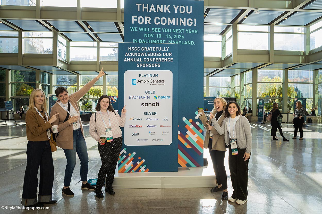 Conference attendees in front of marketing billboard at Seattle Convention Center