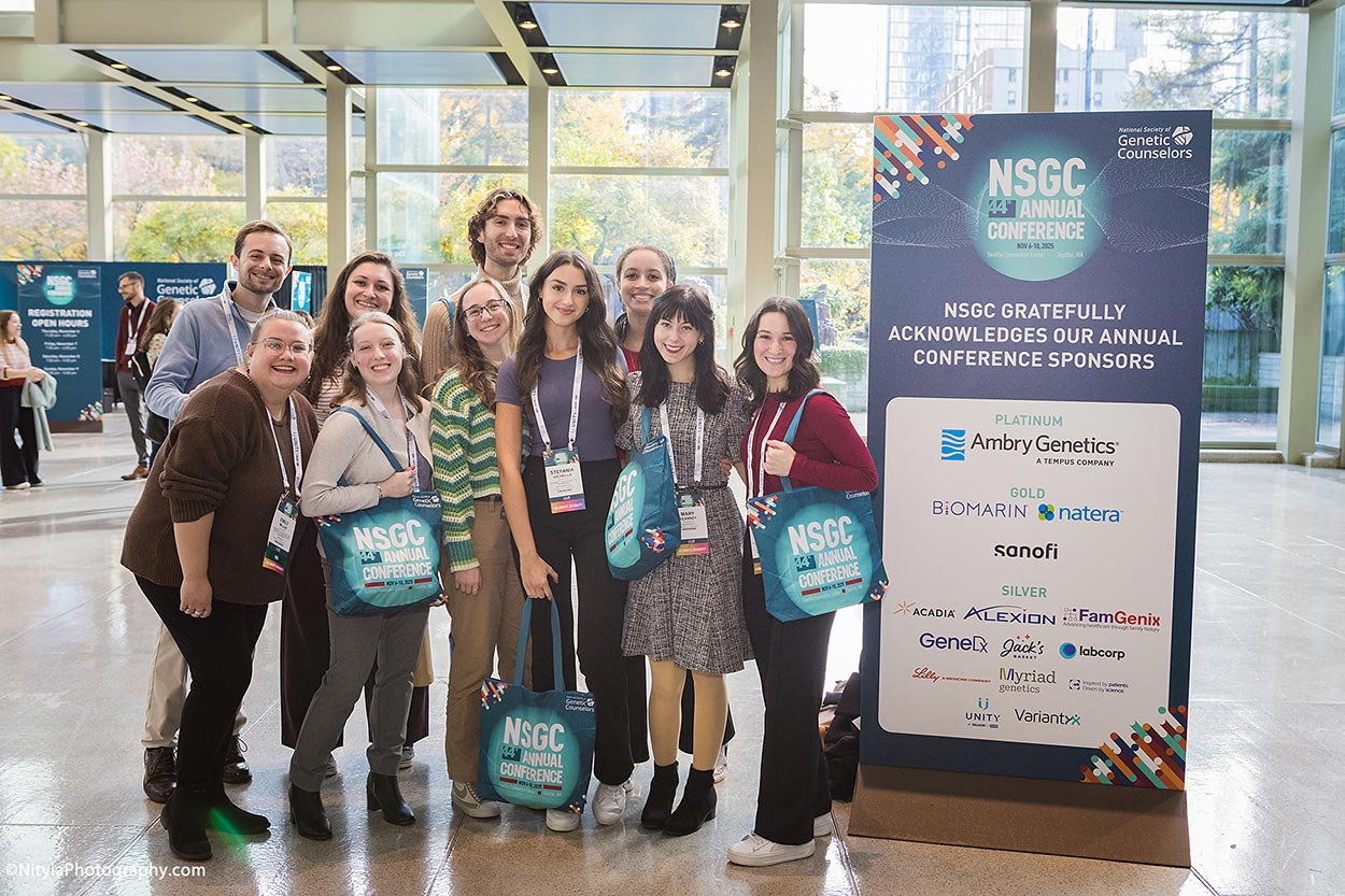 Group of conference attendees in sun-drenched atrium at Seattle Convention Center